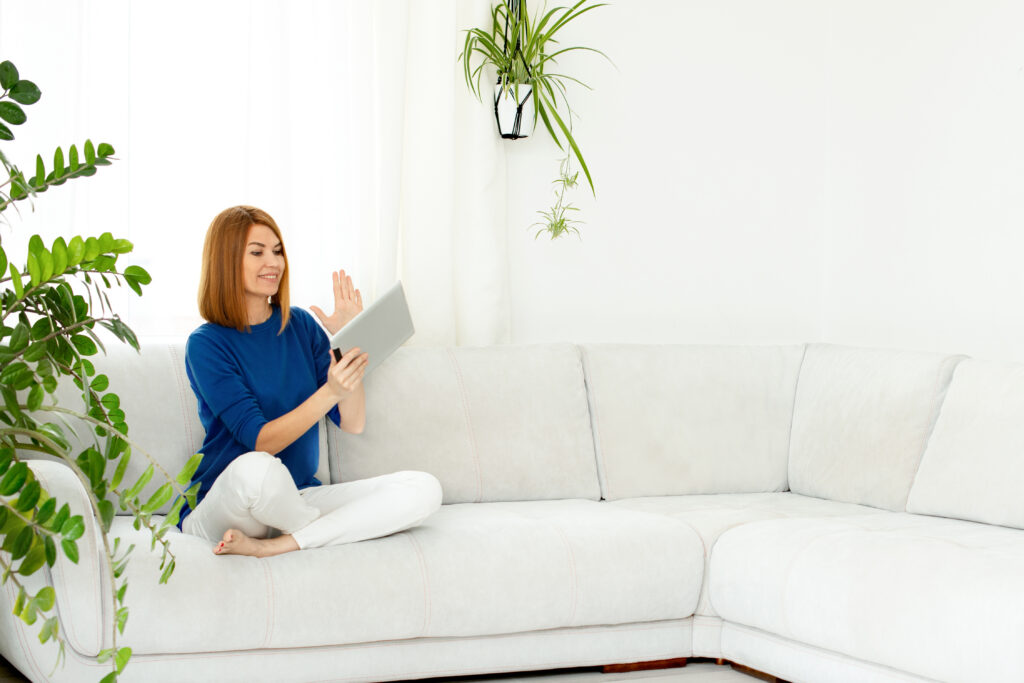 girl-talking-phone-smiling-real-woman-home-white-interior-copy-space