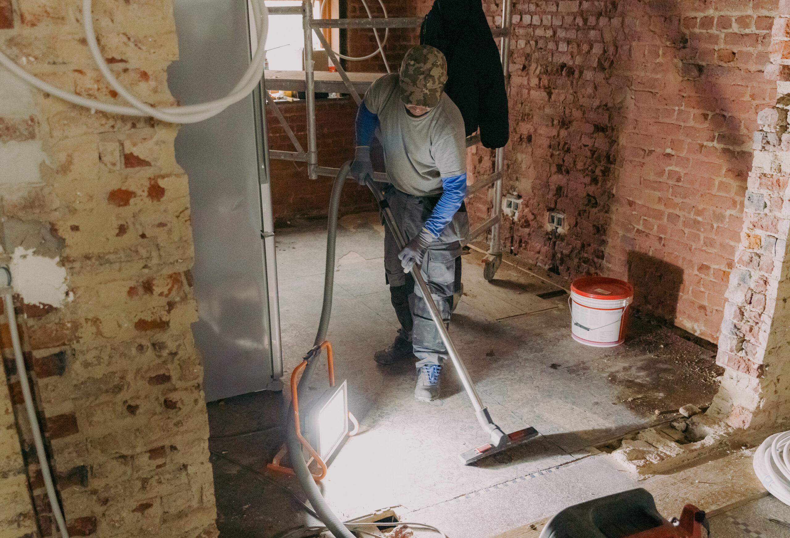 young-man-vacuums-landing-repair-room young-man-vacuums-landing-repair-room