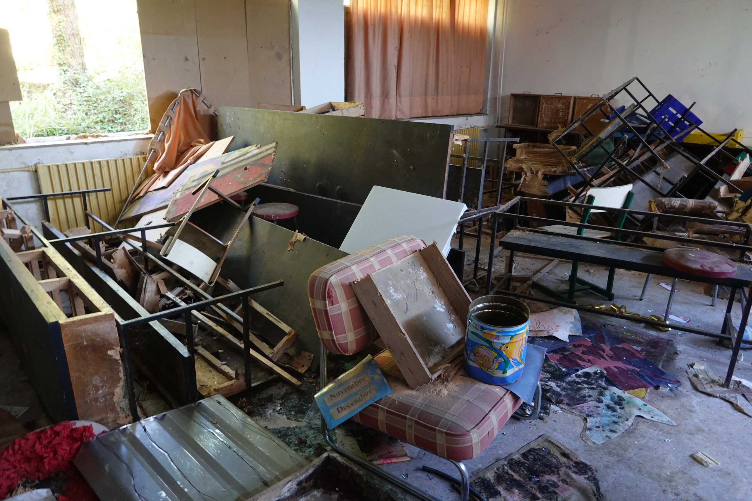 cluttered-abandoned-school-room-with-broken-furniture